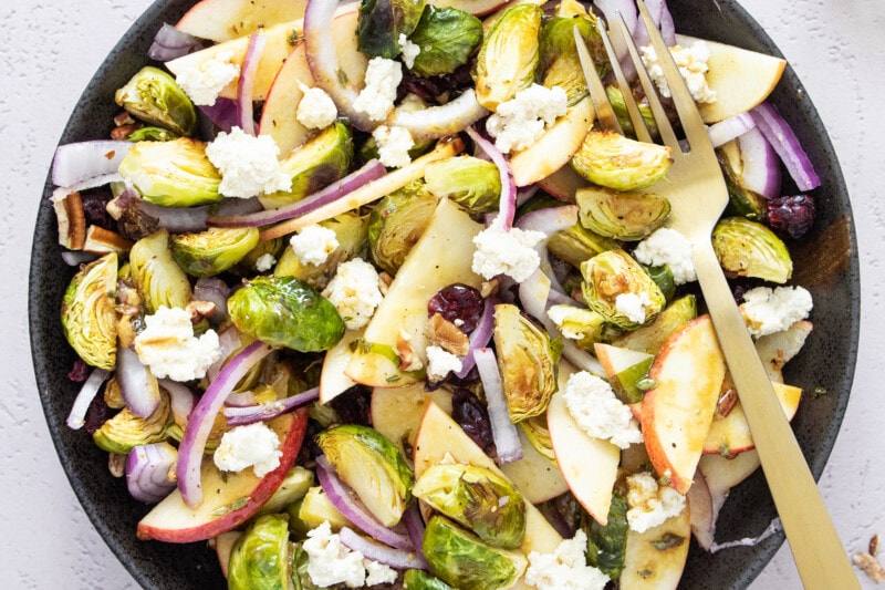 Roasted Brussels sprouts salad on a black plate