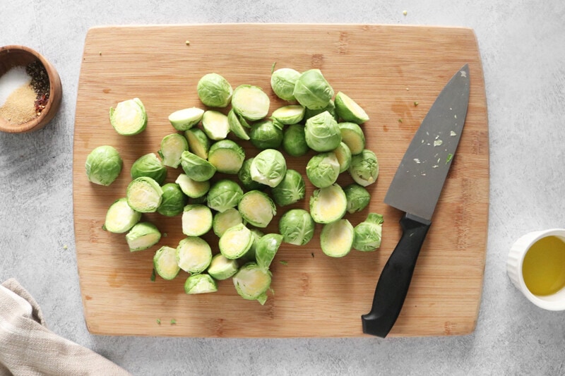 Sliced Brussels sprouts on a wooden cutting board