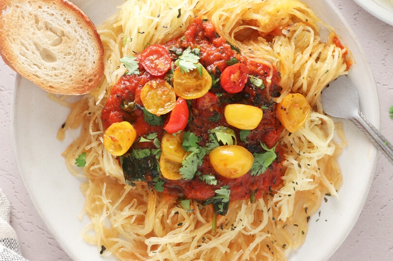 Spaghetti squash pasta with tomato sauce on a white plate.