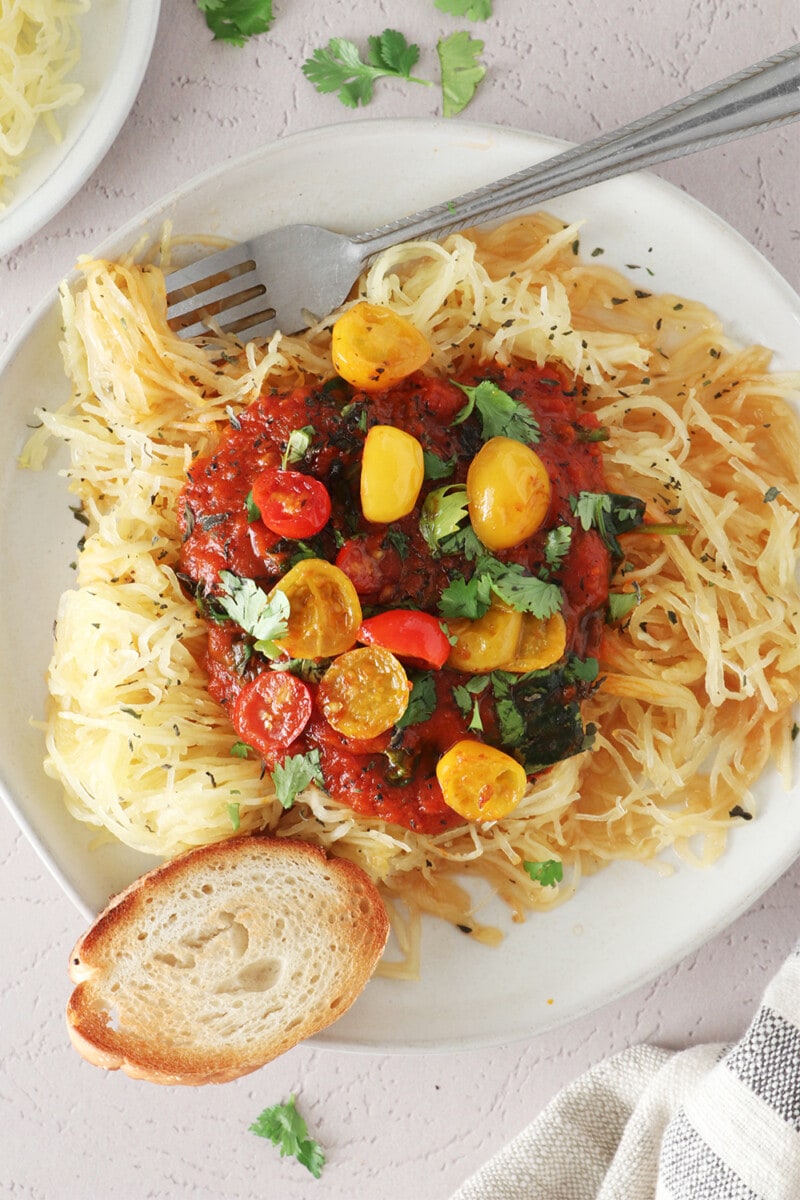 Spaghetti squash pasta with tomato sauce on a white plate.
