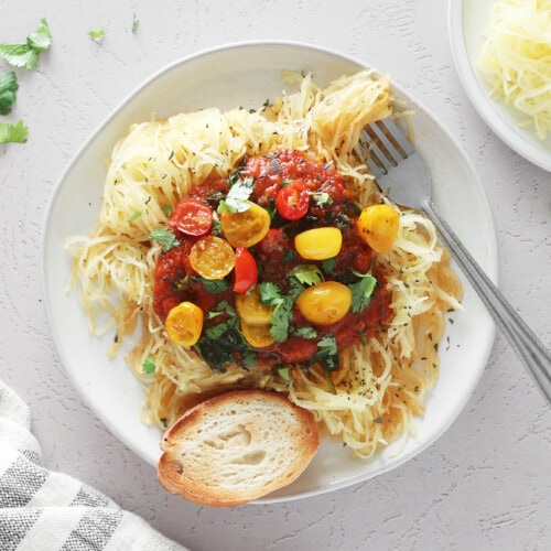 Spaghetti squash pasta with tomato sauce on a white plate