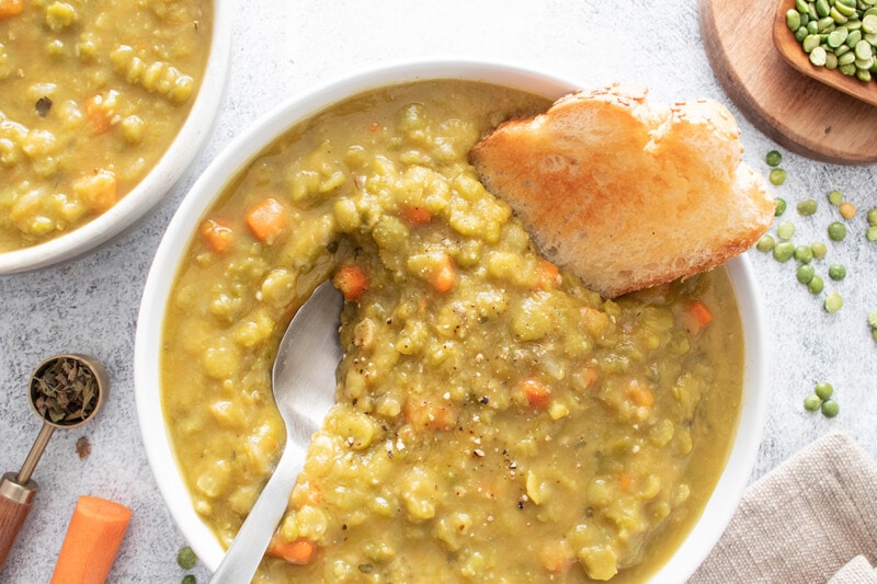 Vegan split pea soup in a bowl, served with toasted bread.