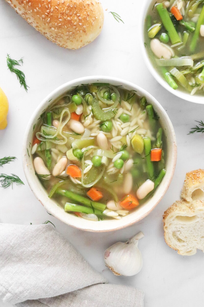 Spring minestrone soup in a white bowl