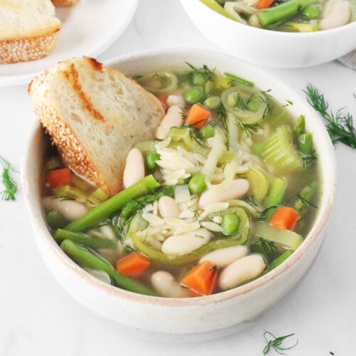 Spring minestrone soup in a white bowl