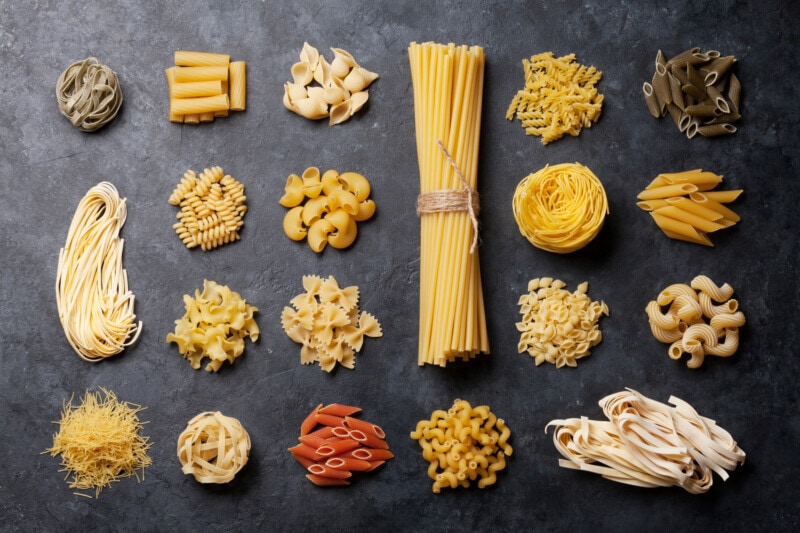 Different types of pasta on a black background.
