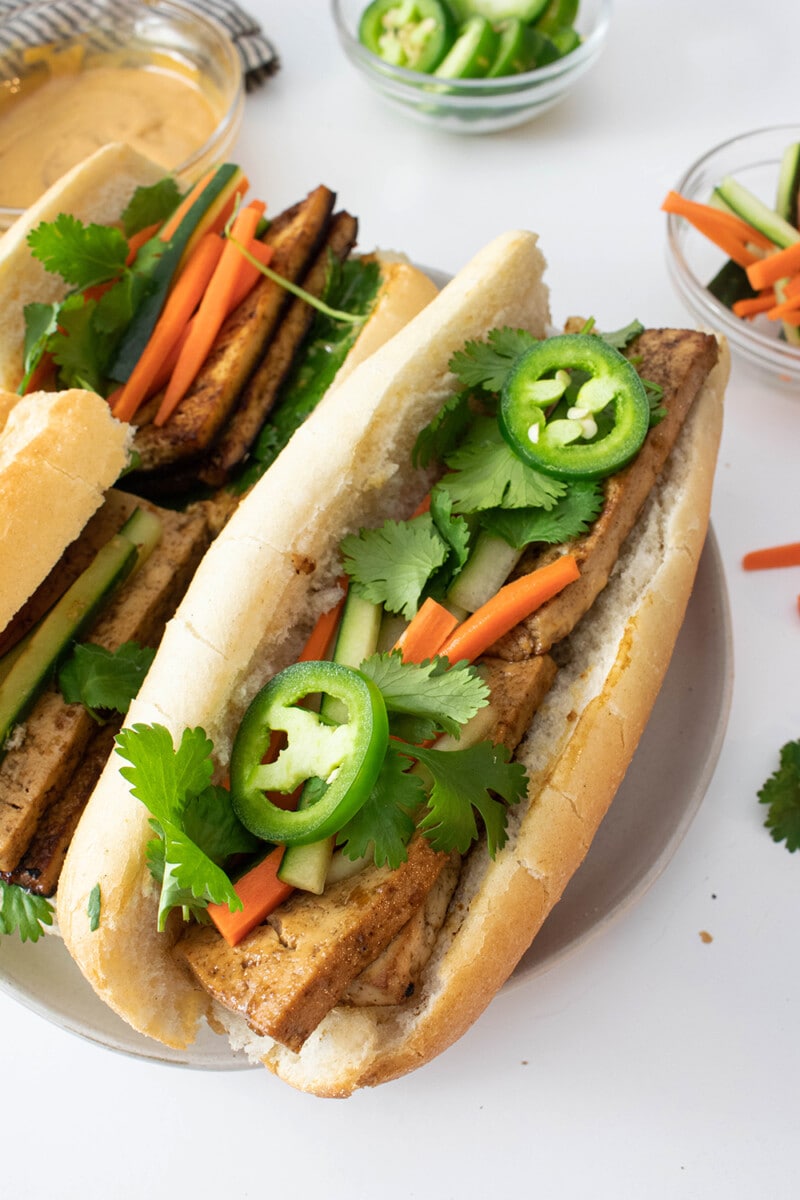 Vegan bánh mì filled with marinated tofu, pickled veggies, and fresh cilantro.