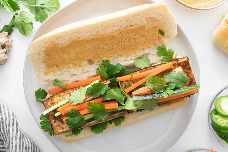 Vegan bánh mì filled with marinated tofu, pickled veggies, and fresh cilantro.