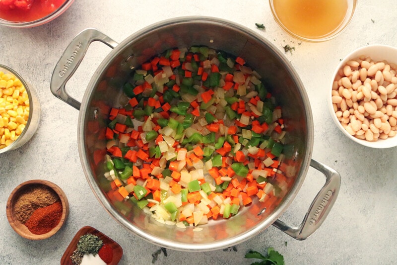Sauté onions, bell peppers, and carrots