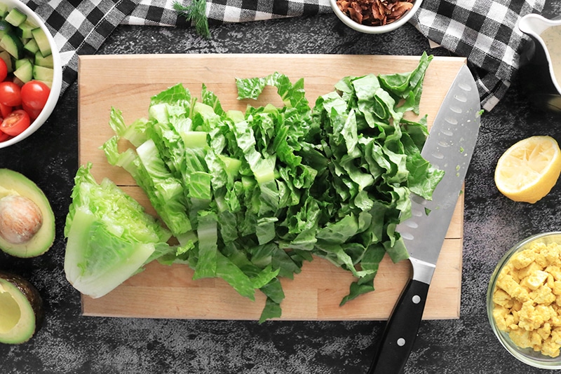 chopped romaine lettuce on a cutting board