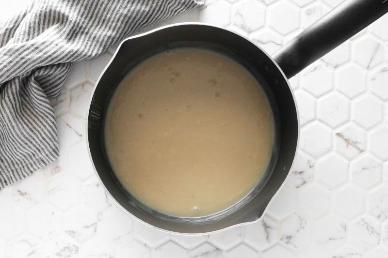 Overhead photo of vegan condensed milk in a small pot after cooking