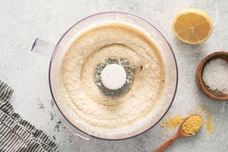 Combining the ingredients in a food processor until smooth.