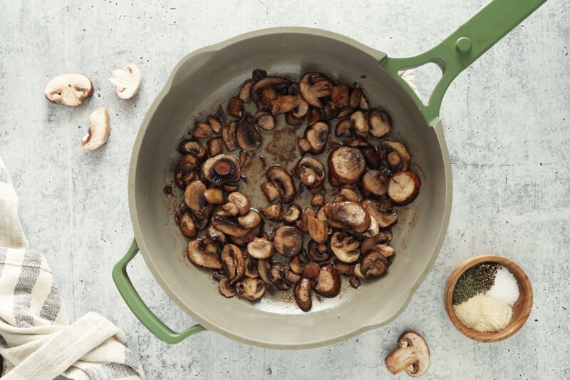 Sautéing mushrooms with butter in a skillet