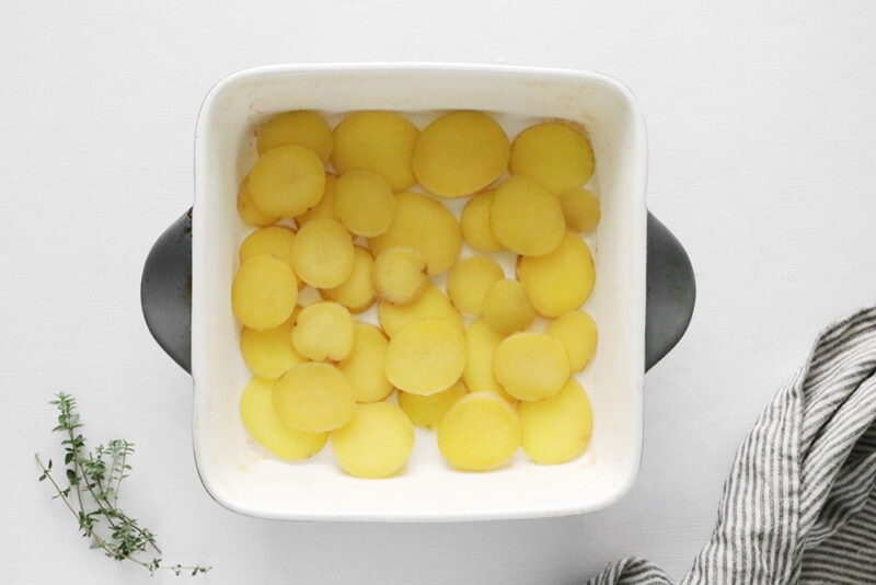 Arranging scalloped potatoes in a casserole dish