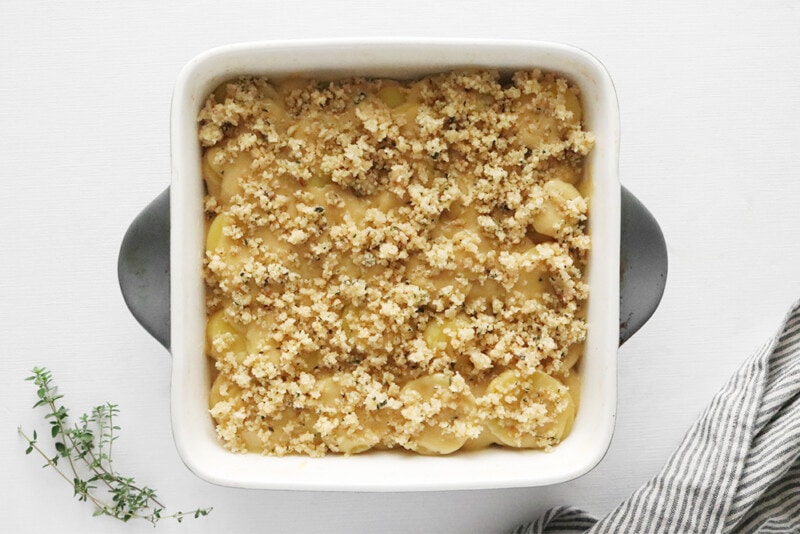 breadcrumb topping on potato and cheese mix in a casserole dish