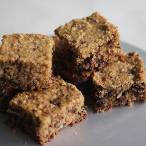 A stack of homemade vegan protein bars on a plate.