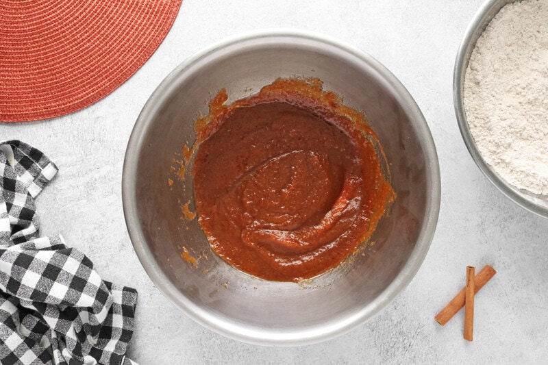 Mix pumpkin puree, applesauce, oil, vanilla extract, and brown sugar in a separate bowl.