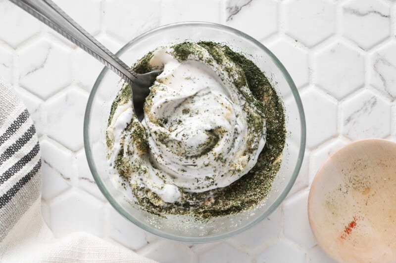 Mixing herbs and spices with vegan mayo