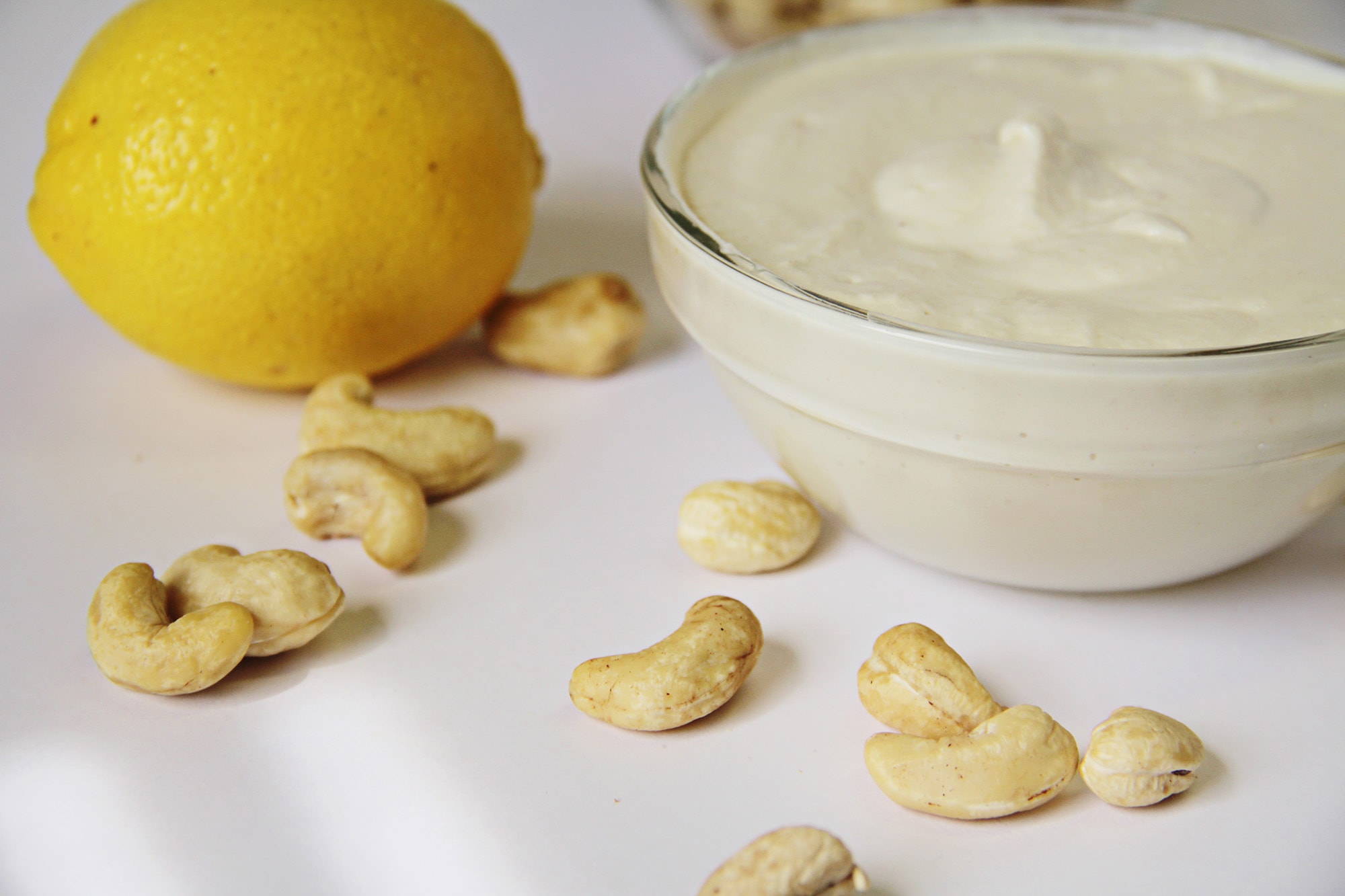 Vegan sour cream made with cashews and lemon in a small bowl.