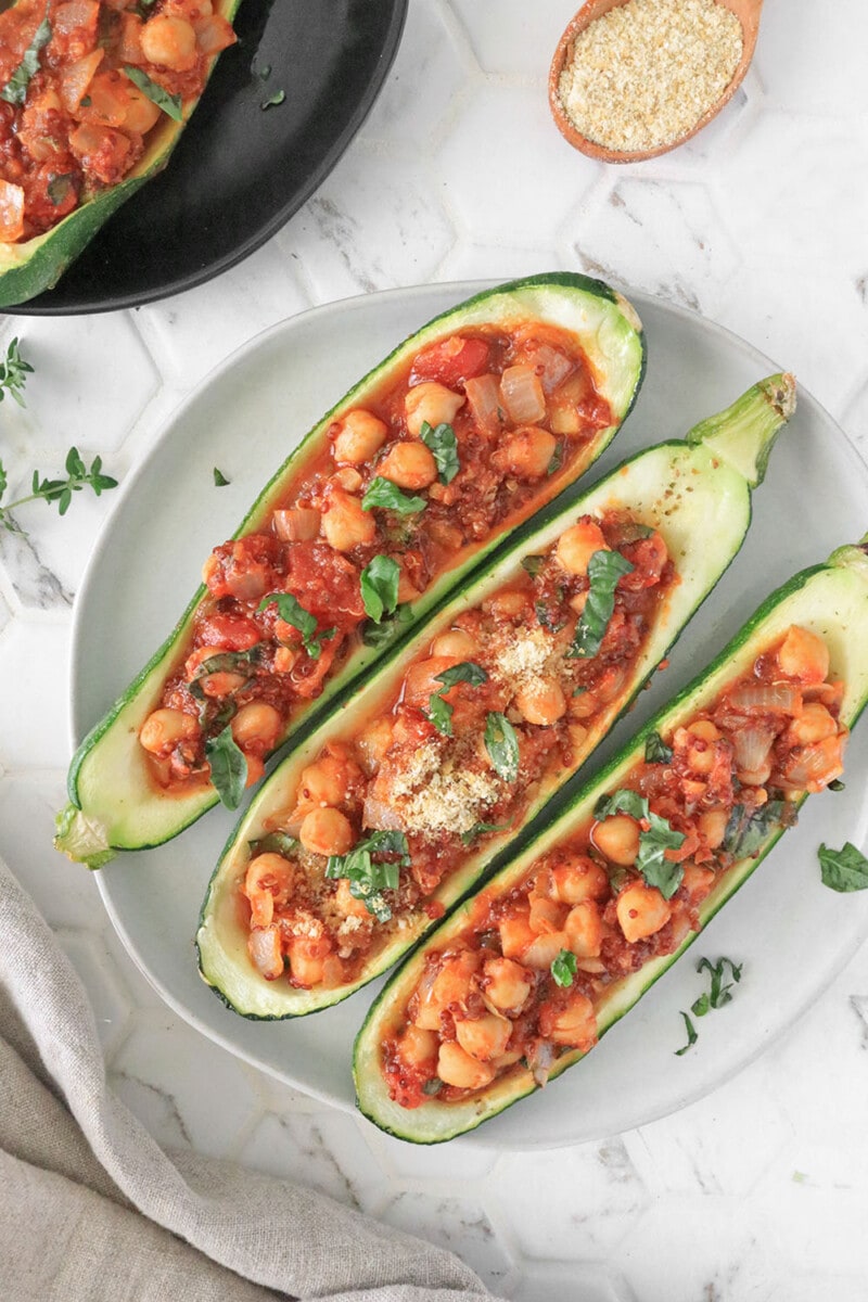 Vegan Stuffed Zucchini Boats on a plate with marble background