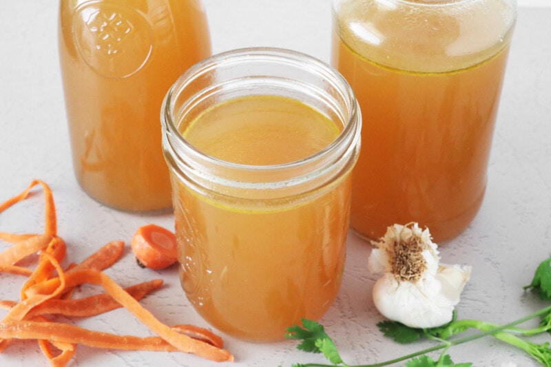 Vegan vegetable broth in glass jars