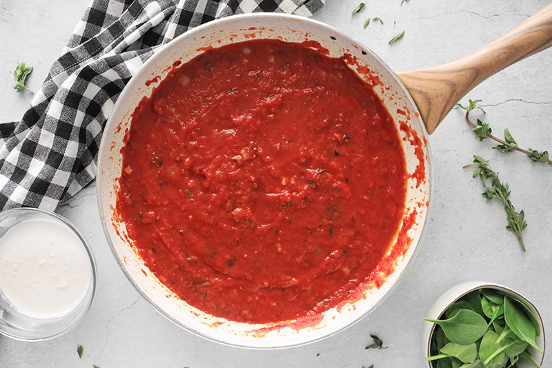 cooking vodka sauce in a frying pan