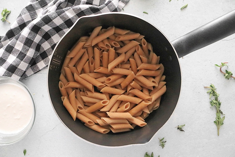 cooking pasta in a sauce pan