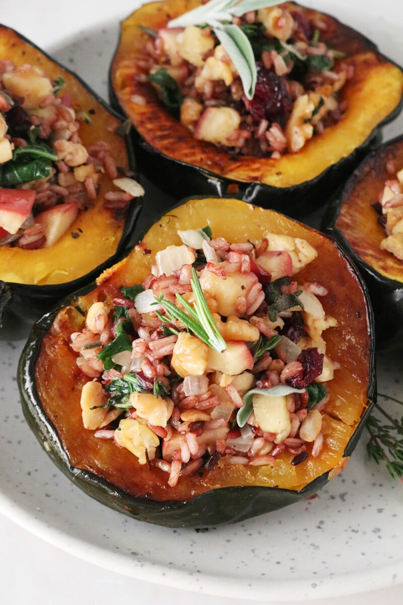 Wild rice stuffed acorn squash, topped with fresh rosemary and sage.