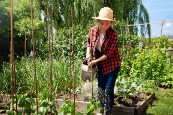Woman watering fall garden