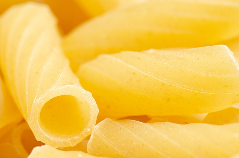 Uncooked ziti pasta close up.